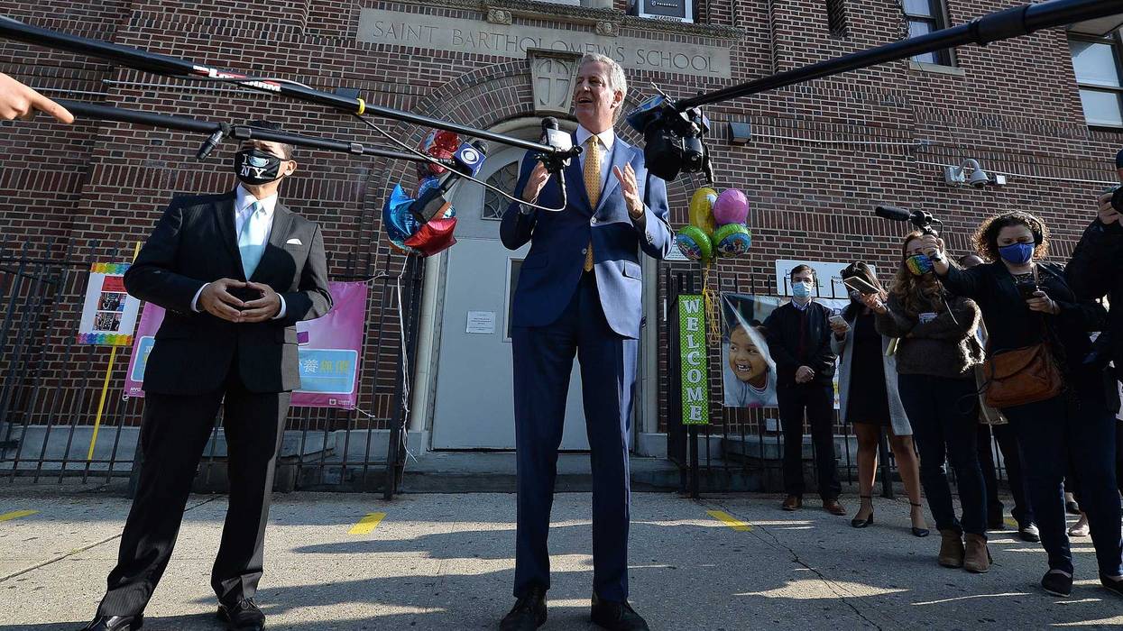 New York City Mayor Bill de Blasio (center) speaks to members of the media as Richard A. Carranza (l), New York City Schools Chancellor of the New York City Department of Education stands by, at Mosaic Pre-K Center, in the Queens borough of New York