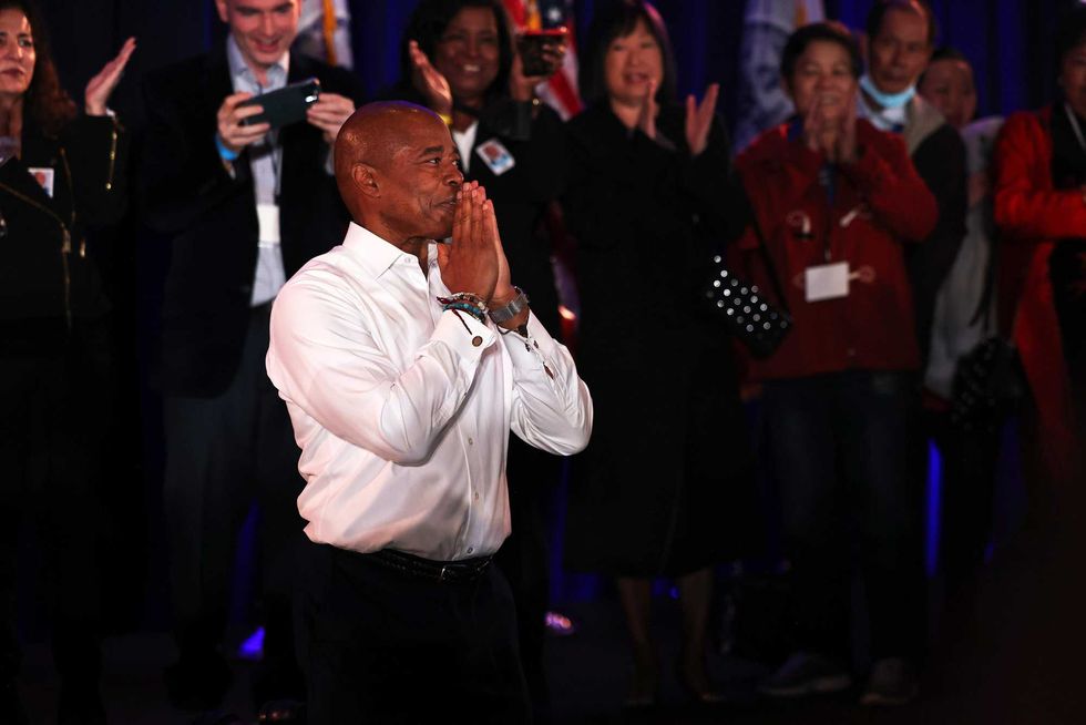 New York City Mayor-elect Eric Adams kneels as he clasps hind hands in prayer as he takes the stage during his election night party at the New York Marriott at the Brooklyn Bridge on November 02, 2021