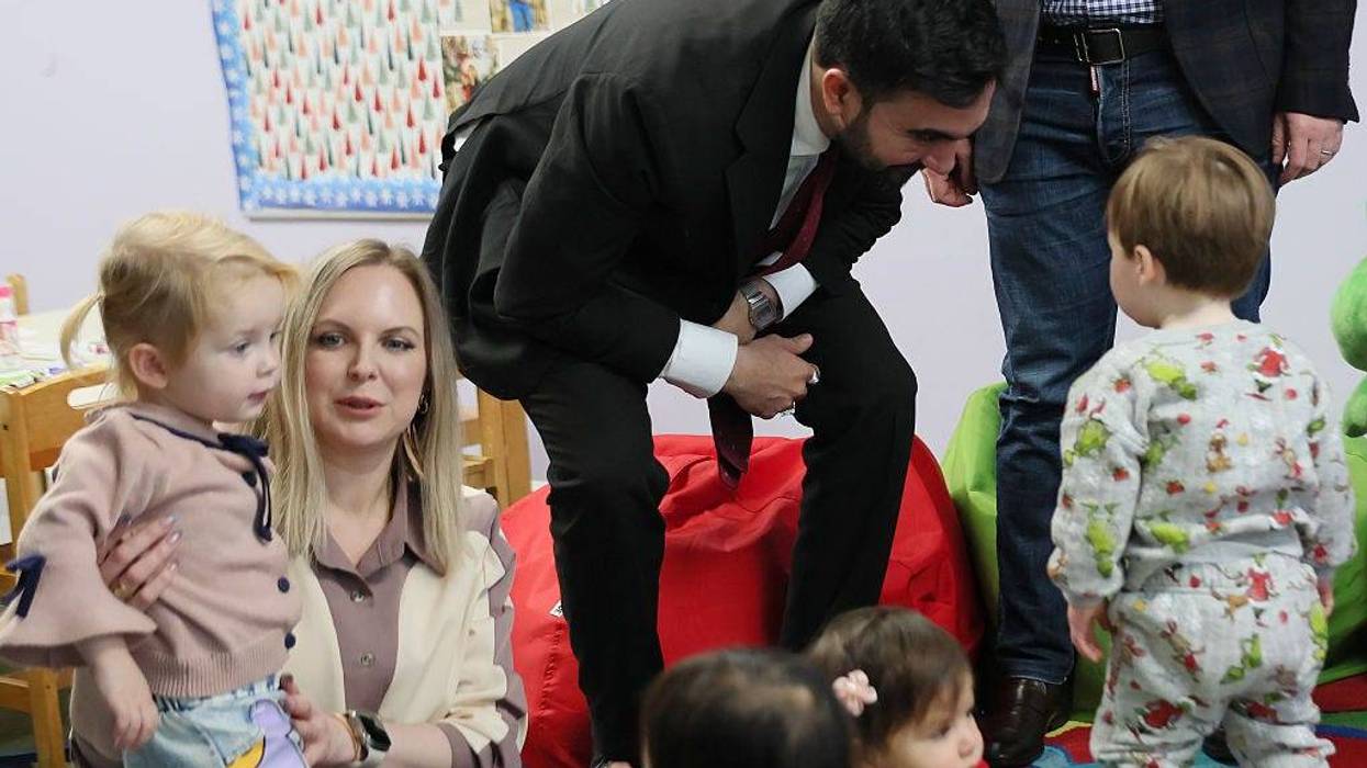 New York City Mayor-elect Zohran Mamdani speaks with a child after reading a Christmas book at Little Scholars on Dec. 11, 2025.