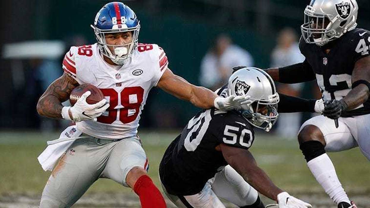 New York Giants tight end Evan Engram holds onto the ball after making a one-handed catch next to Oakland Raiders linebacker Nicholas Morrow (50) in the fourth quarter at Oakland Coliseum on Dec 3, 2017.