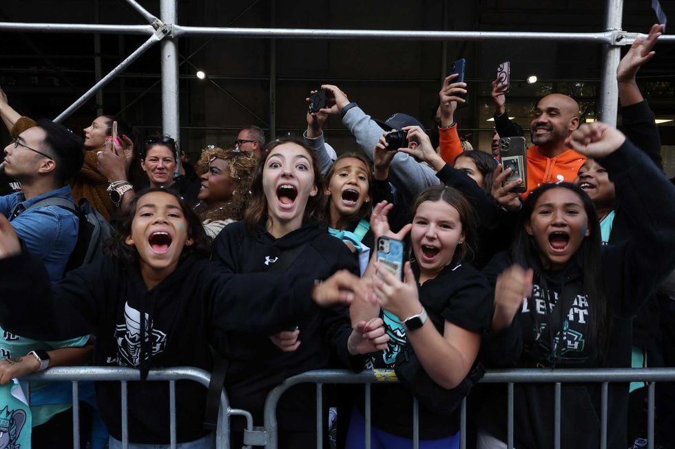 New York Liberty fans celebrate their WNBA championship during their parade on Broadway on October 24, 2024
