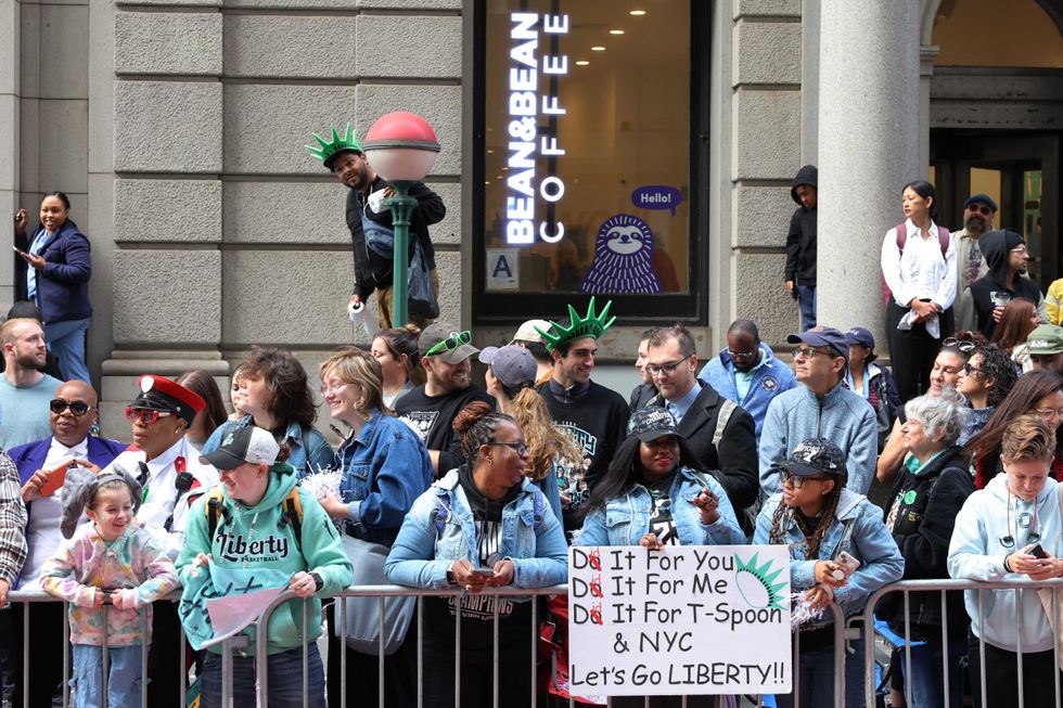 New York Liberty fans wait for the start of their WNBA championship parade on Broadway on October 24, 2024 in New York City