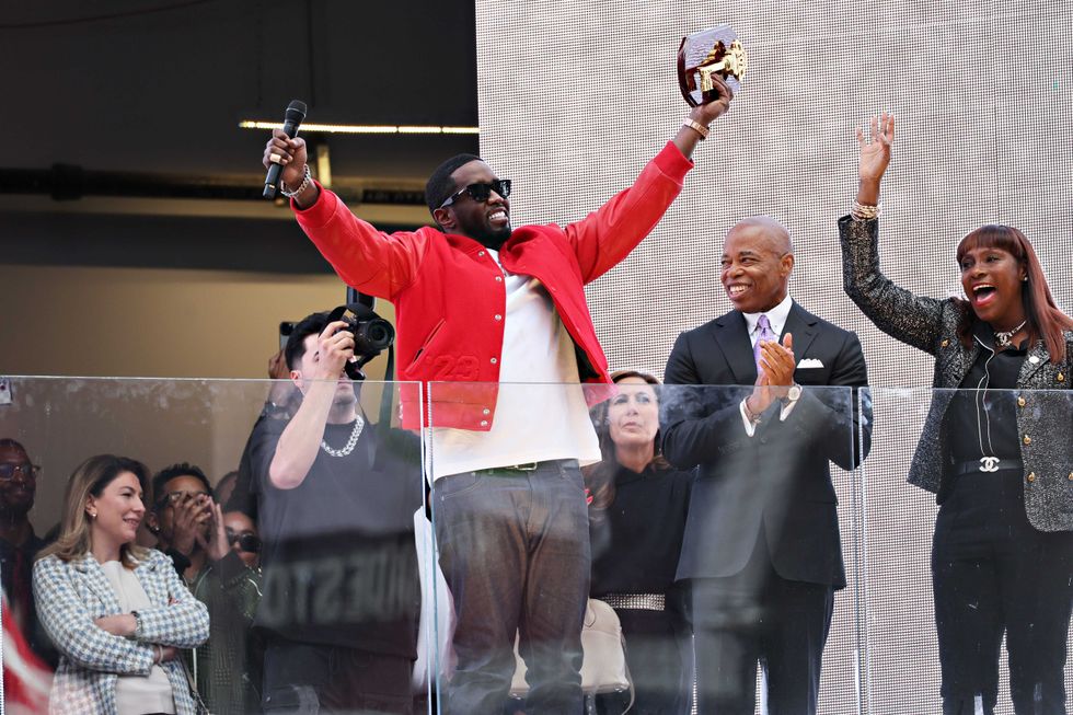 New York Mayor Eric Adams (R) presents Sean "Diddy" Combs with the keys to the city in Times Square on September 15, 2023 in New York City.