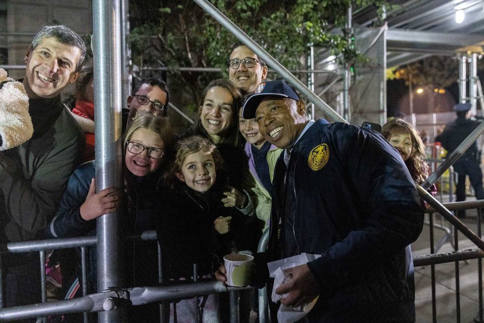 New York Mayor Eric Adams talks a selfie with visitors during the Macys Thanksgiving Day Parade balloon Inflation