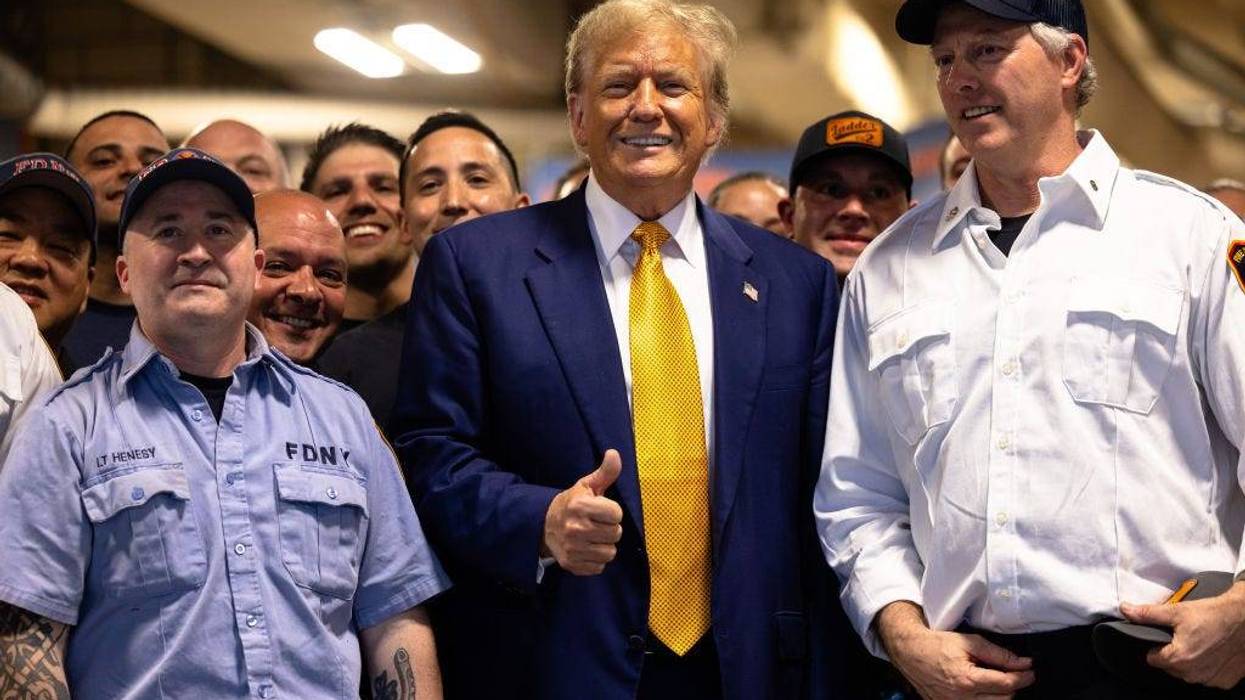 NEW YORK, NEW YORK - MAY 02: Republican presidential candidate former U.S. President Donald Trump poses for photos with members of the FDNY Engine 2, Battalion 8 firehouse on May 02, 2024 in New York City. Trump delivered pizza to a firehouse after a court appearance in his hush money trial, which started with a hearing where prosecutors argued that Judge Juan Merchan should find Trump in criminal contempt again for violating a gag order. Earlier this week, Trump was found in contempt for nine violations of his April 1 order prohibiting criticism of witnesses and jurors. (Photo by Michael M. Santiago/Getty Images)