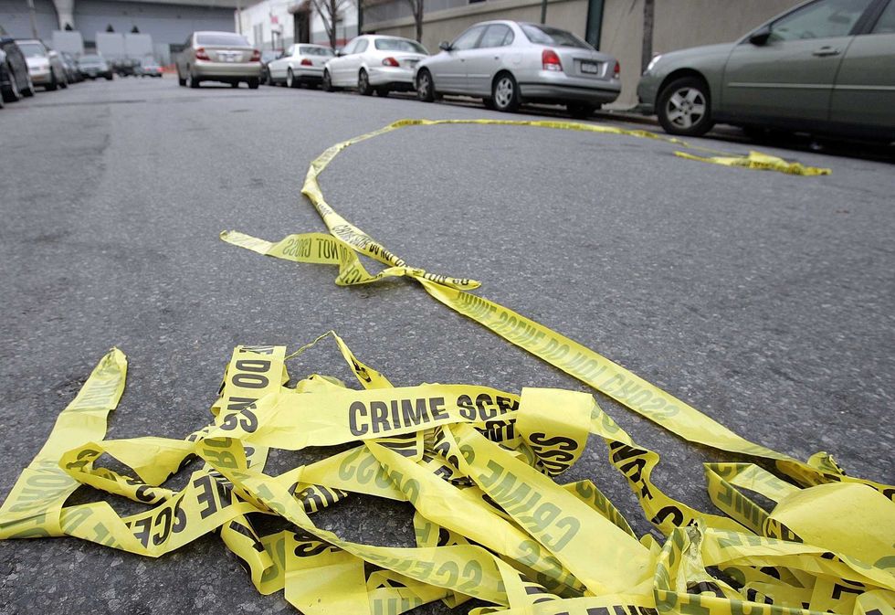 NEW YORK - NOVEMBER 28: Police crime scene tape lies in the street outside Club Kalua club where Sean Bell was shot and killed November 28, 2006 in Jamaica, Queens, New York City. Sean Bell was killed and two friends wounded when New York City police fired 50 shots at them outside a strip club after Bell
