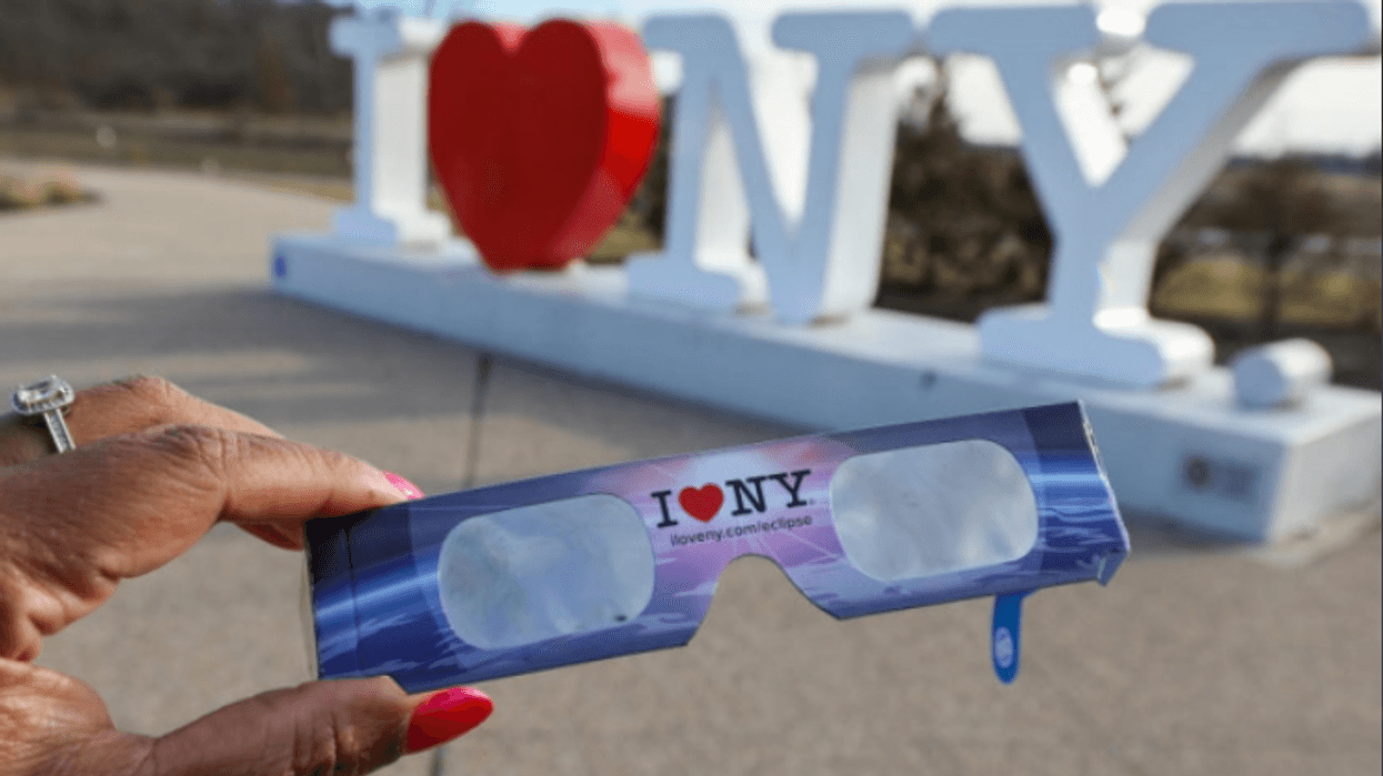 NEW YORK, NY - AUGUST 21: People view the solar eclipse at 'Top of the Rock' observatory at Rockefeller Center, August 21, 2017 in New York City. While New York City is not in the path of totality for the solar eclipse, around 72 percent of the sun will be covered by the moon during the peak time of the partial eclipse. (Photo by Drew Angerer/Getty Images)