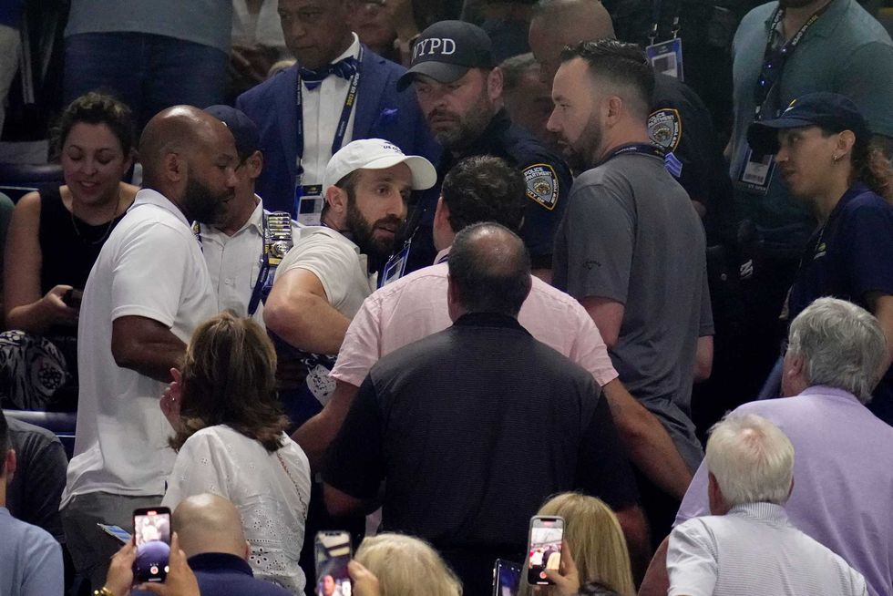 New York police and USTA officials accost protestors in the crowd who disrupted play between Coco Gauff, of the United States, and Karolina Muchova, of the Czech Republic, during the women