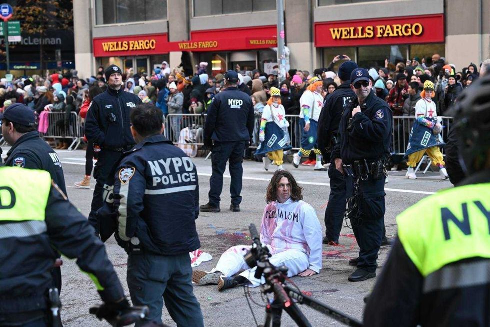New York Police Department (NYPD) members intervene and take two pro-Palestinian protesters into custody, who entered the parade, during the traditional Thanksgiving Day parade in New York, United States on Nov. 23, 2023.