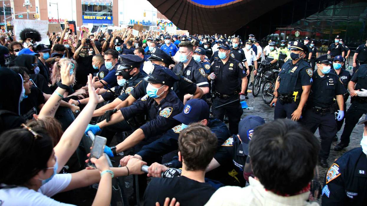 New York Police Department (NYPD) officers gather as activists hold a rally in response to the police killing George Floyd in front of Barclays Center on May 29, 2020 in the Brooklyn borough of New York City. Brooklyn joined nationwide protests following the police killing of George Floyd on May 25. Four Minneapolis police officers have been fired after a video taken by a bystander was posted on social media showing Floyd's neck being pinned to the ground by an officer as he repeatedly said, "I can’t breathe". Floyd was later pronounced dead while in police custody after being transported to Hennepin County Medical Center.