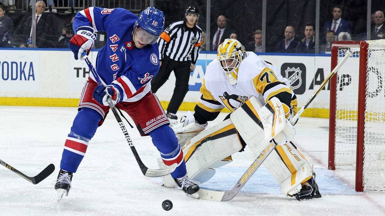 New York Rangers center Andrew Copp (18) plays the puck in front of Pittsburgh Penguins goaltender Louis Domingue (70) during the third overtime