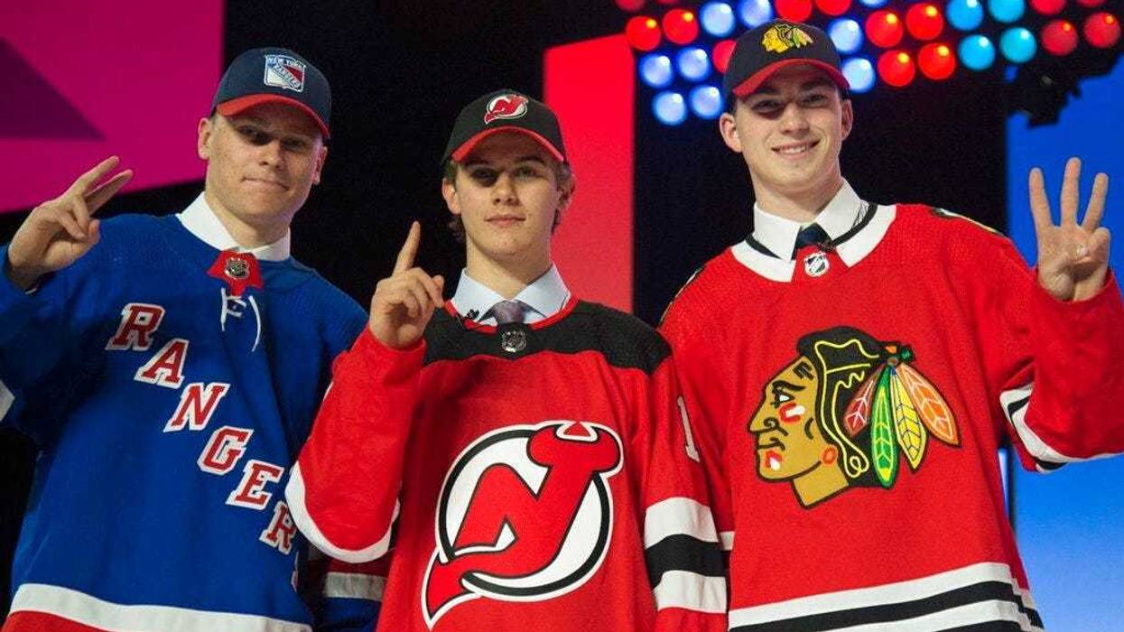 New York Rangers draft pick Kaapo Kakko, left; New Jersey Devils pick Jack Hughes, center; and Chicago Blackhawks pick Kirby Dach pose for photos during the first round of the NHL hockey draft