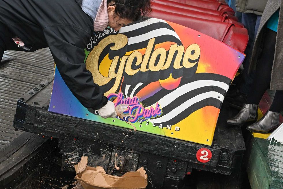 New York State Senator Diane Savino christens the cyclone by breaking an egg cream over it on the Luna Park opening day of the season at Coney Island.