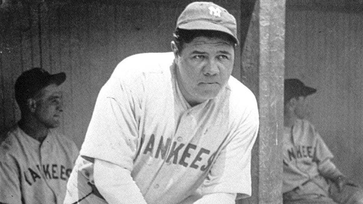 New York Yankees' Babe Ruth, who was injured, stands in the dugout during the baseball team's game at Cleveland