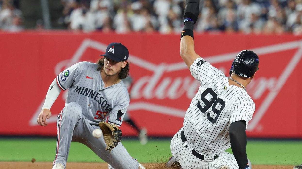 New York Yankees designated hitter Aaron Judge (99) steals second base as Minnesota Twins third baseman Ryan Fitzgerald (53) catches the throw during the fourth inning at Yankee Stadium.