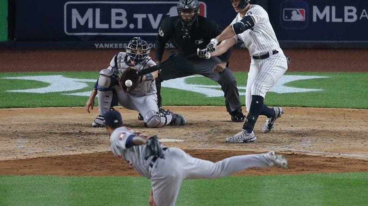 New York Yankees designated hitter Giancarlo Stanton (27) hits an RBI single against Houston Astros relief pitcher Bryan Abreu (66) during the sixth inning at Yankee Stadium.
