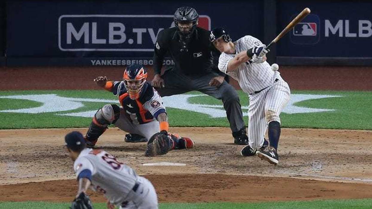 New York Yankees first baseman DJ LeMahieu (26) hits an RBI infield single against Houston Astros relief pitcher Bryan Abreu (66) during the sixth inning at Yankee Stadium.