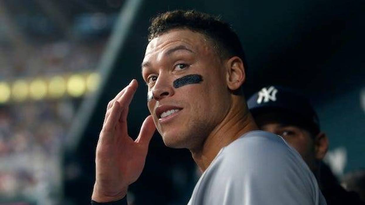 New York Yankees right fielder Aaron Judge (99) smiles in the dugout after hitting home run number sixty-two to break the American League home run record