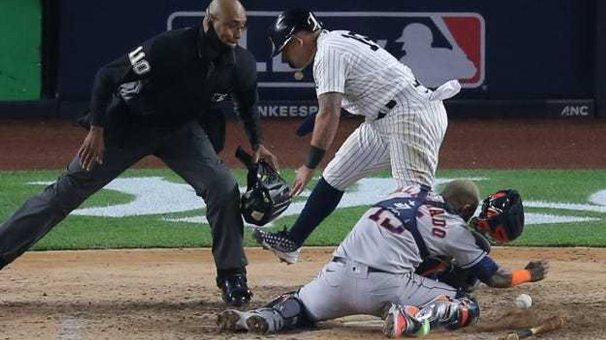 New York Yankees second baseman Rougned Odor (18) collides with Houston Astros catcher Martin Maldonado (15) while scoring on a hit by Yankees first baseman DJ LeMahieu (not pictured) during the sixth inning.