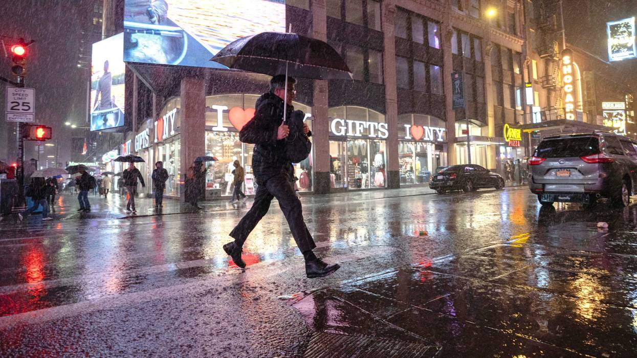 New Yorkers walk through Times Square during a rain storm on March 6, 2024