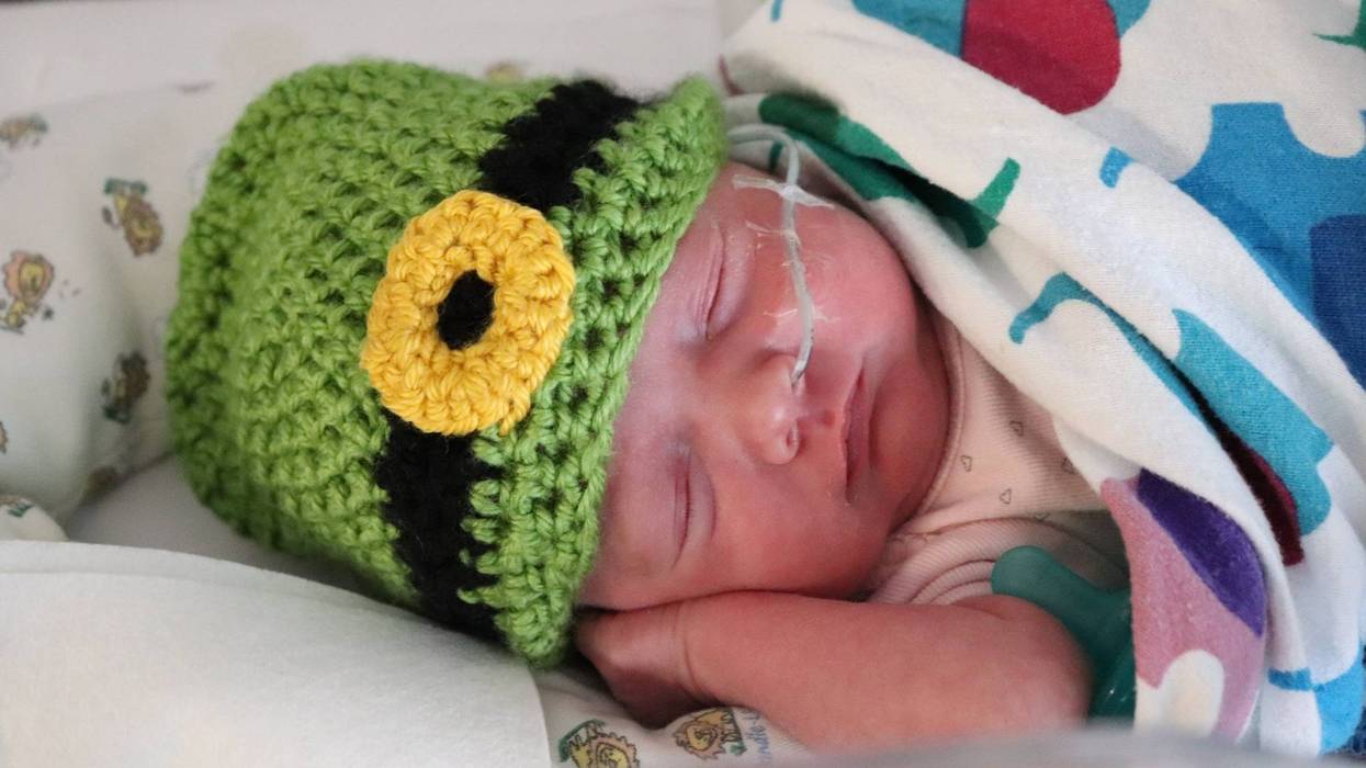 Newborn with leprechaun hat on St. Patrick's Day 2022
