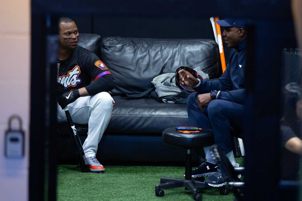 Newly acquired San Francisco Giants designated hitter Rafael Devers (16) chats with former Giants star Barry Bonds before his first game with his new team against the Cleveland Guardians at Oracle Park.