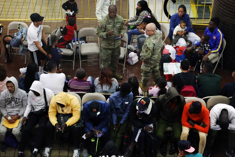 Newly arrived asylum seekers wait in a holding area at the Port Authority bus terminal before being sent off to area shelters and hotels on May 15, 2023 in New York City. The historic Roosevelt Hotel in midtown is being prepped to reopen shortly to accommodate an anticipated influx of asylum seekers into New York City. With migrants arriving weekly on buses from Texas and other parts of the country, Mayor Eric Adams
