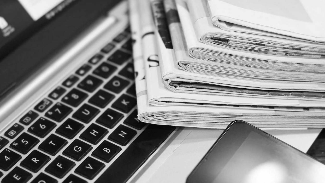 News. Newspapers, Laptop and Smartphone - Sources of Information. Finance Magazines and Journals Stacked in Pile on Keyboard of Computer. Business Concept