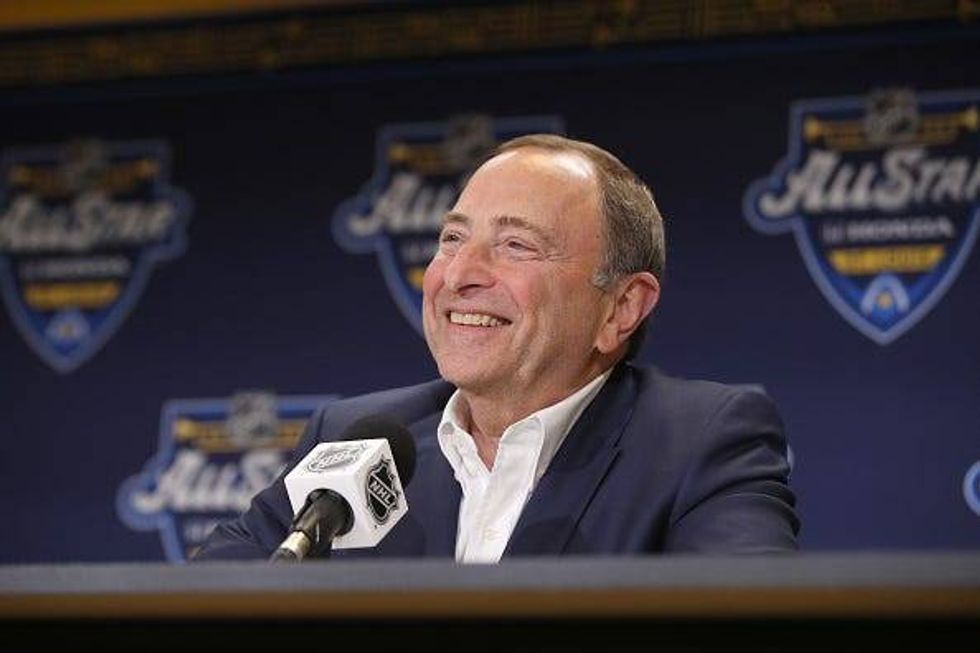 NHL Commissioner Gary Bettman laughs during a press conference.
