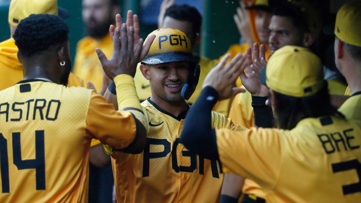 Nick Gonzales (39) reacts in the dugout after scoring against the Padres