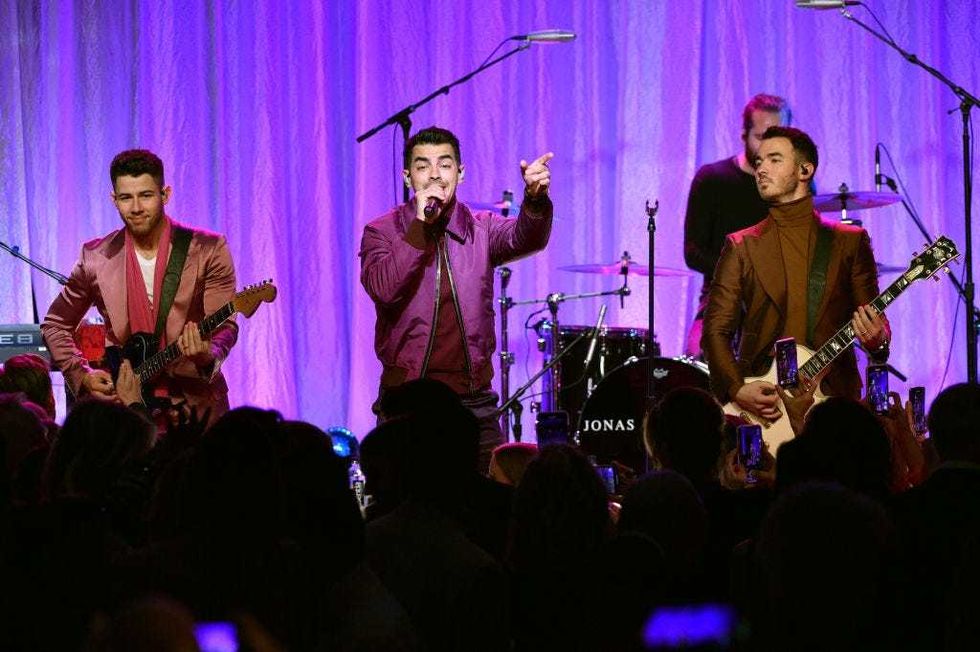 Nick Jonas, Joe Jonas, and Kevin Jonas of The Jonas Brothers perform onstage during WCRF