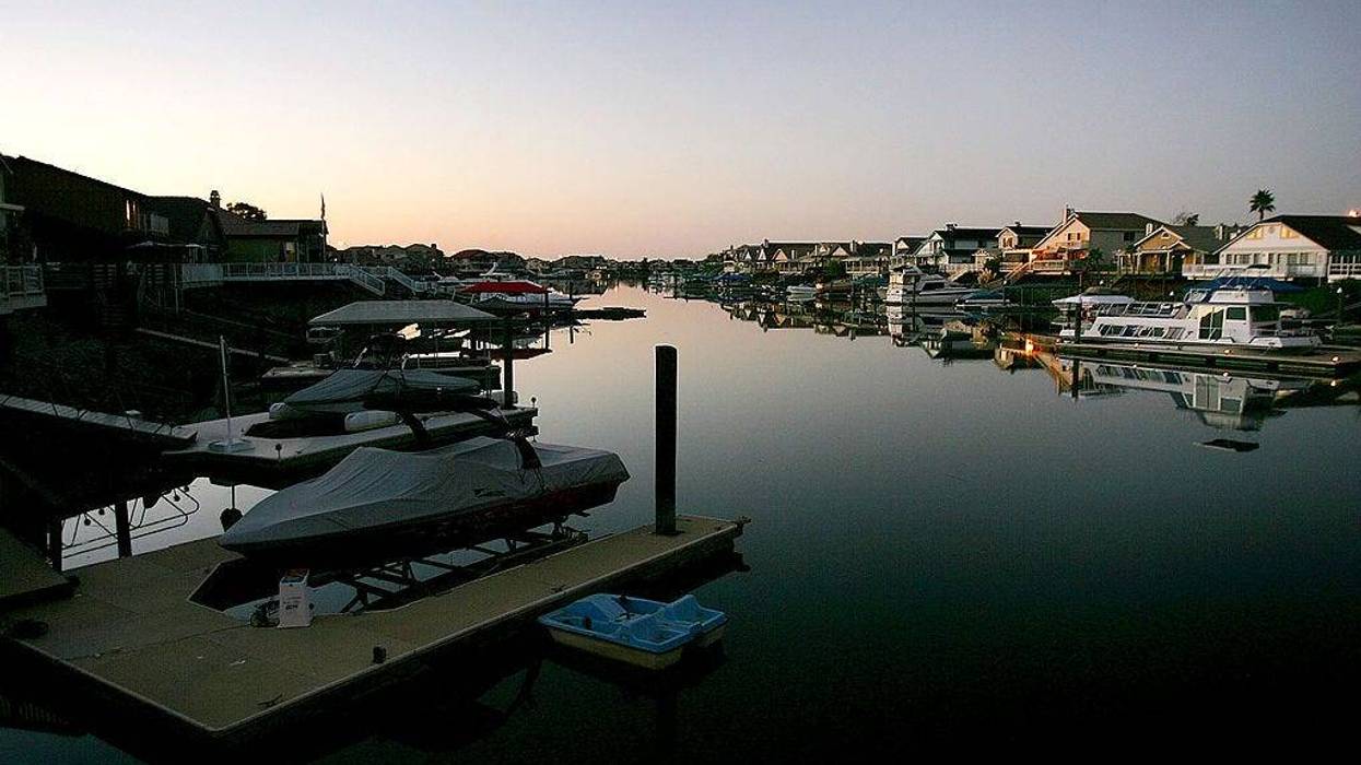 Night falls on a new development of large tract homes with docks and boats in the community of Discovery Bay, one of the residential islands surrounded by levees that hold back higher the waters of the Sacramento-San Joaquin River Delta, on September 28, 2005 west of Stockton, California.