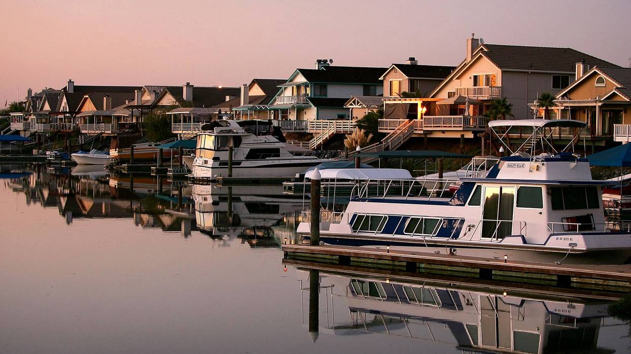 Night falls on a new development of large tract homes with docks and boats in the community of Discovery Bay.