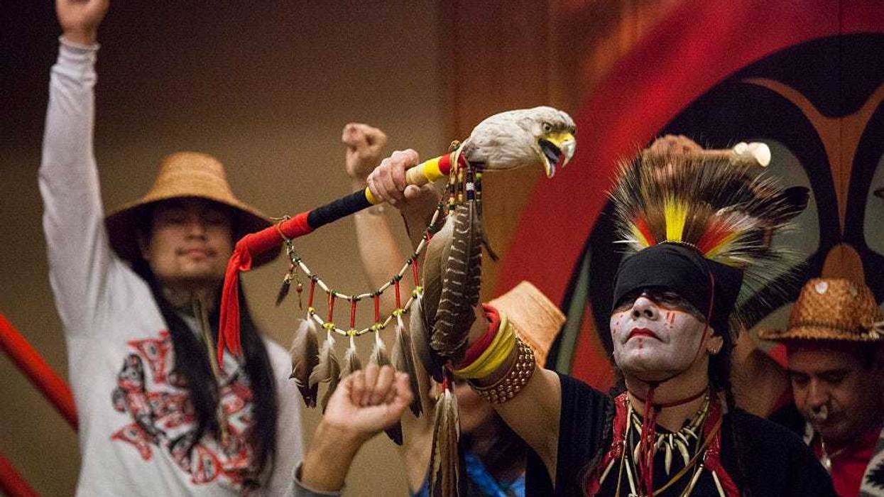 Nikk "Red Weezil" Dakota (R), from the Turtle Mountain Band of Chippewa, celebrates with others from various tribes during Indigenous Peoples' Day events at the Daybreak Star Cultural Center on October 13, 2014 in Seattle, Washington.
