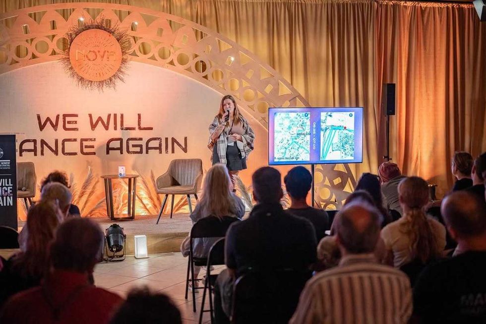 Noa Beer talks to patrons at the Nova Exhibition