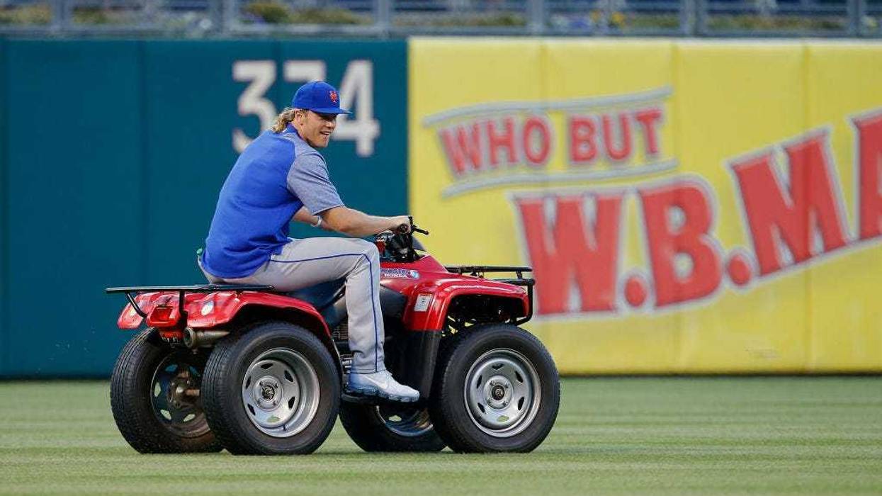 Noah Syndergaard, then #34 of the New York Mets, steals the Phillies Phanatic's ATV before a game against the Philadelphia Phillies at Citizens Bank Park on April 10, 2017.