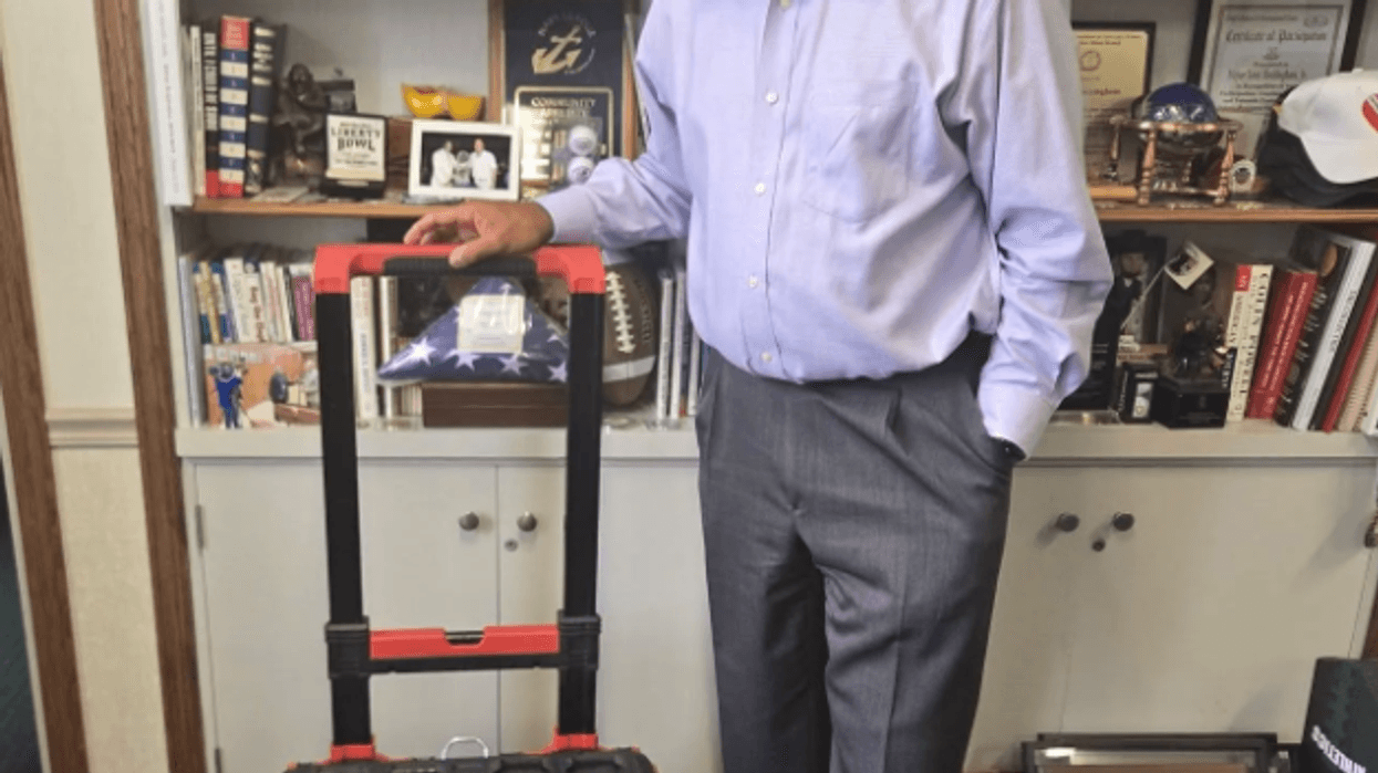 North Chicago Mayor Leon Rockingham, Jr with Toolbox he saw fall from truck and returned
