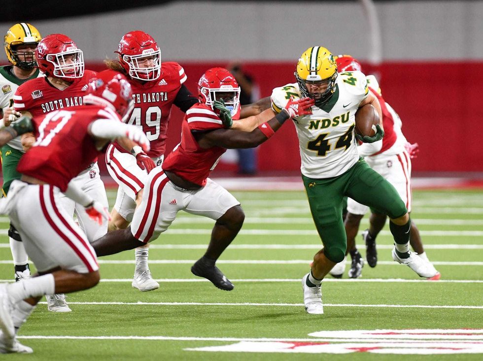 North Dakota State s Hunter Luepke holds off a South Dakota player during a football game on Saturday, September 24, 2022, at the DakotaDome in Vermillion.