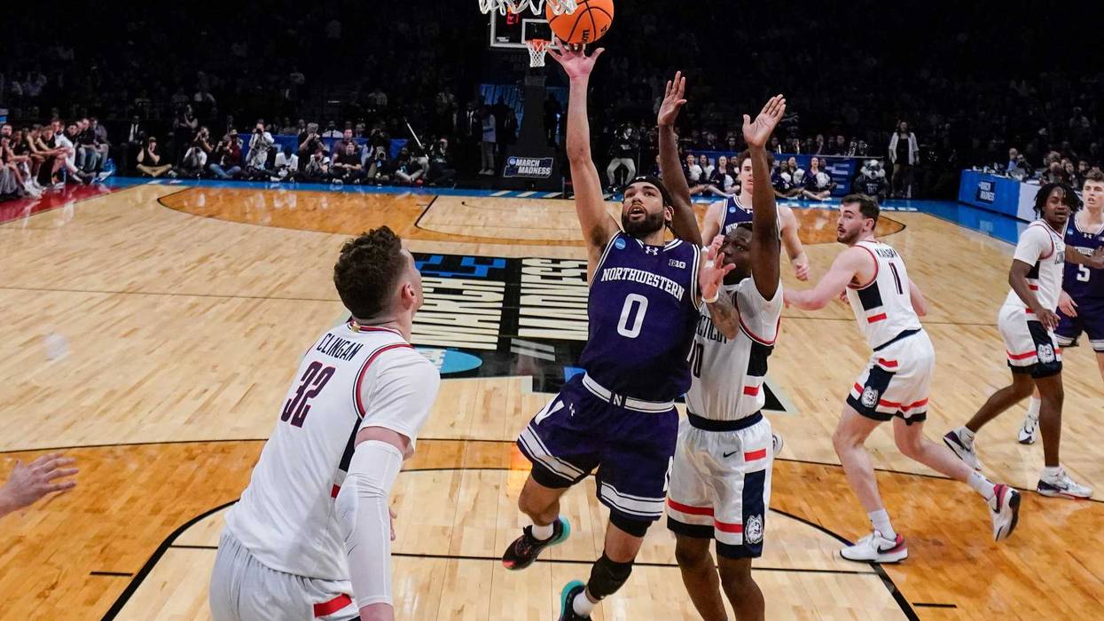 Northwestern's Boo Buie (0) drives past UConn's Hassan Diarra (10) during the first half of a second-round college basketball game in the NCAA Tournament Sunday, March 24, 2024, in New York.