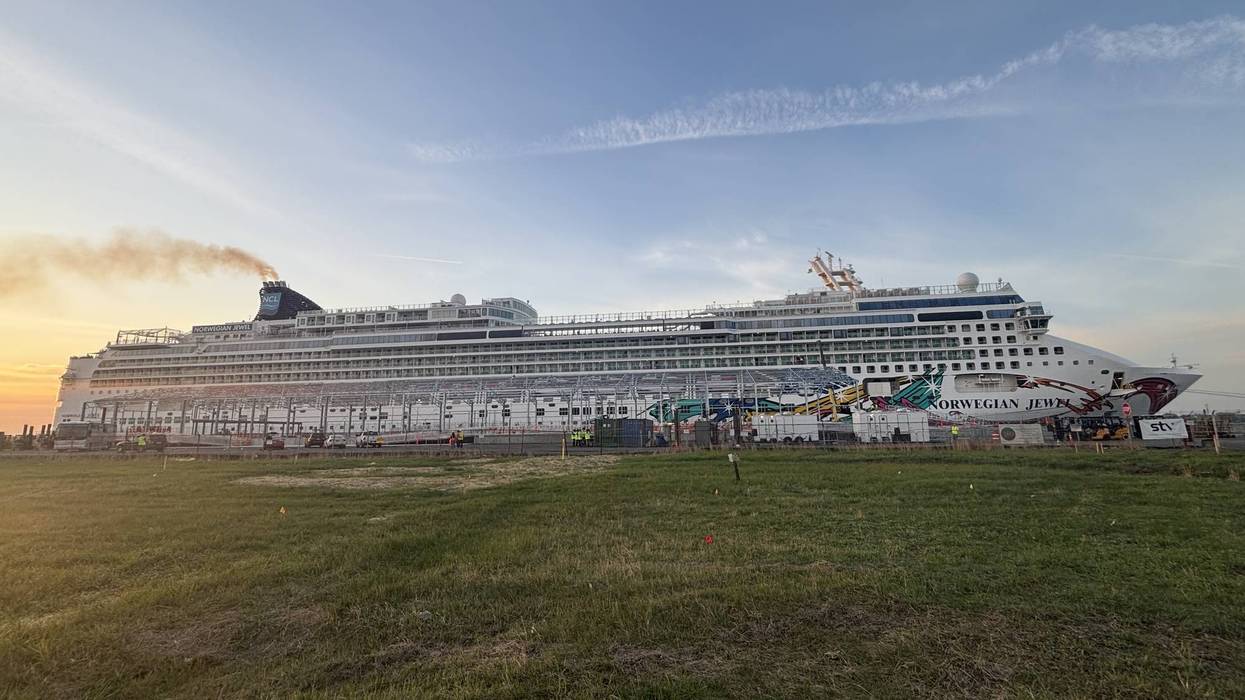 Norwegian Jewel cruise ship docked at sunrise.