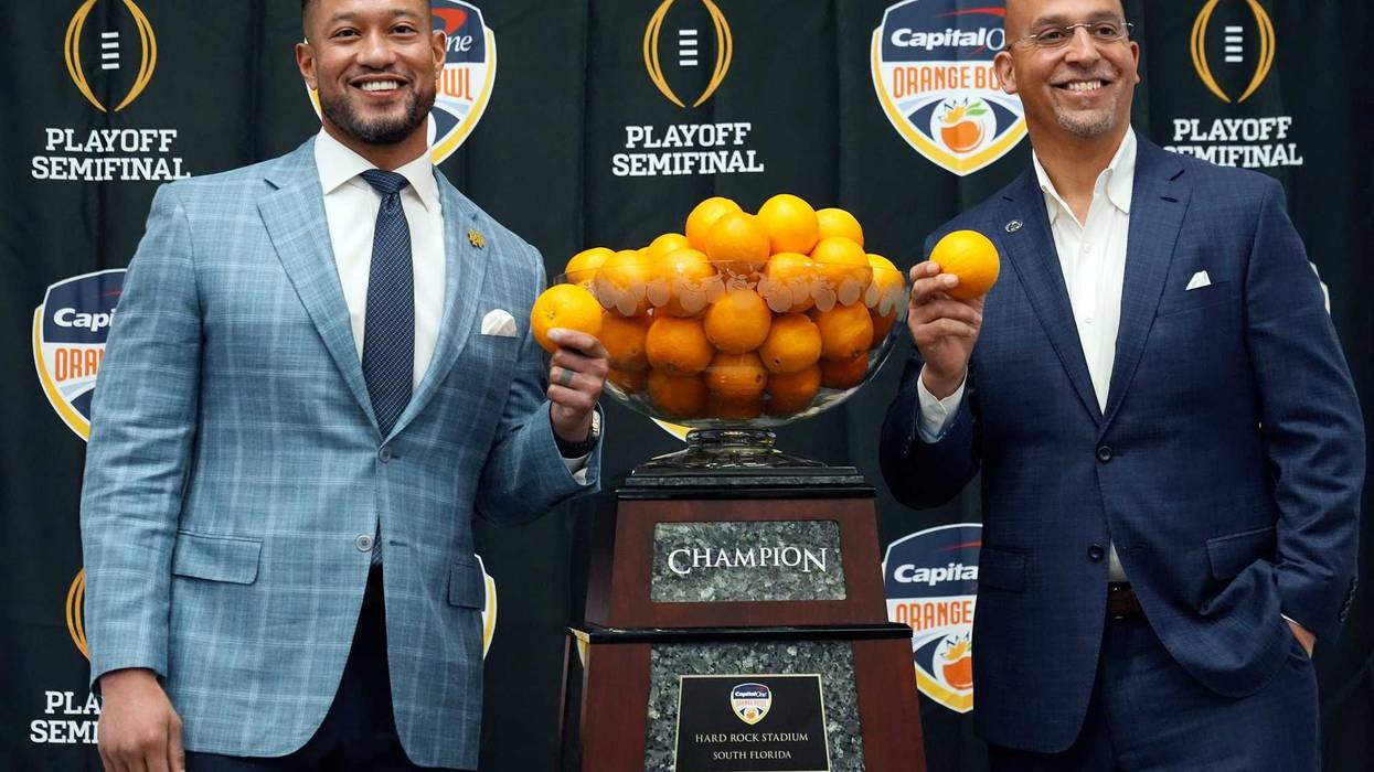 Notre Dame head coach Marcus Freeman, left, and Penn State head coach James Franklin pose with the trophy during a news conference for the Orange Bowl NCAA College Football Playoff game, Wednesday, Jan. 8, 2025, in Dania Beach, Fla.