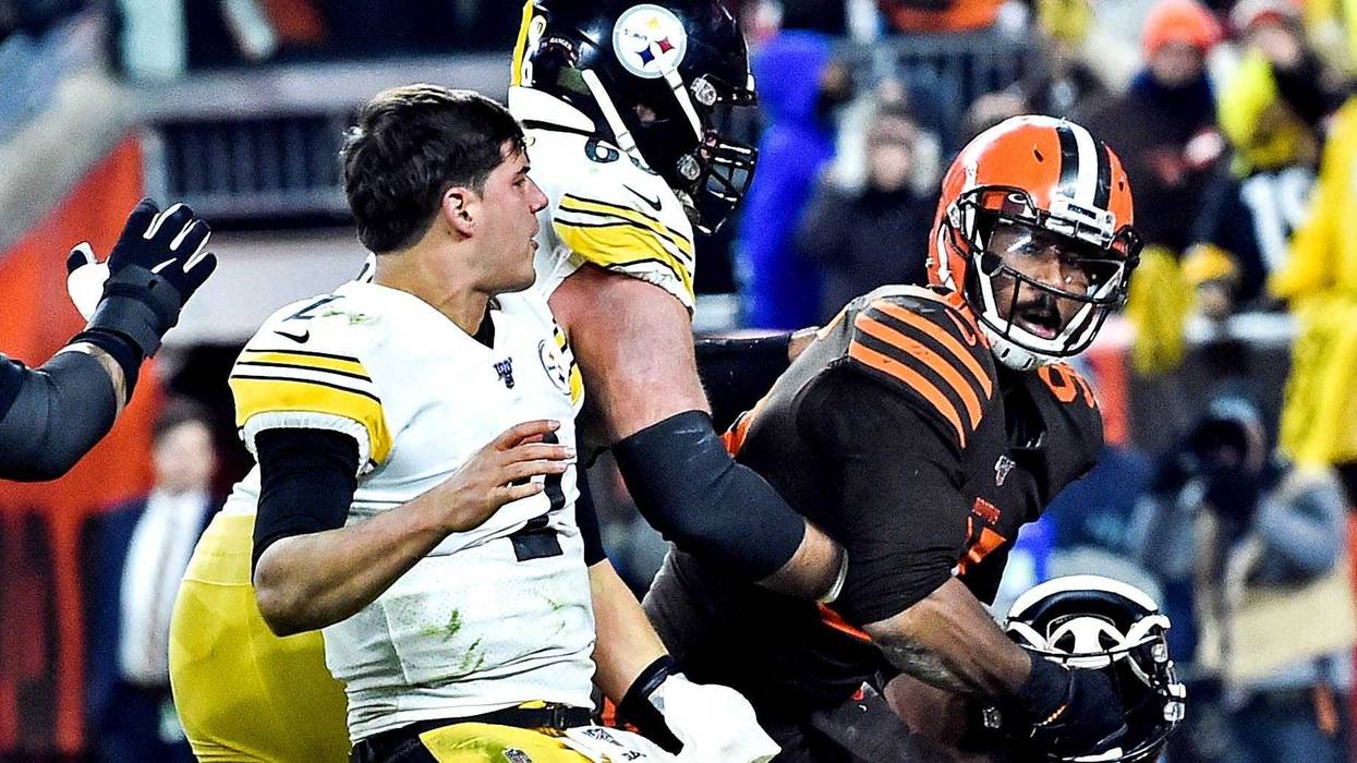 Nov 14, 2019; Cleveland, OH, USA; Cleveland Browns defensive end Myles Garrett (95) hits Pittsburgh Steelers quarterback Mason Rudolph (2) with his own helmet as offensive guard David DeCastro (66) tries to stop Garrett during the fourth quarter at FirstE