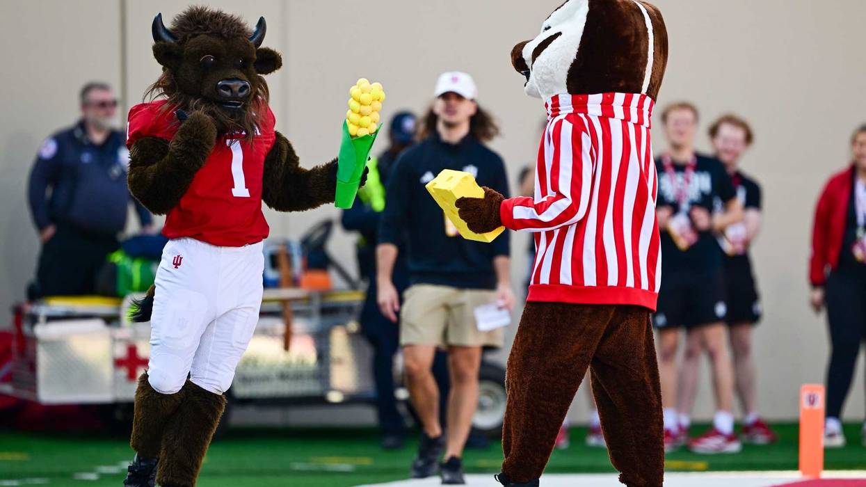 Nov 15, 2025; Bloomington, Indiana, USA; The Indiana Hoosiers Bison compares his corn to the cheese of the Wisconsin Badgers Badger during the second half at Memorial Stadium. Mandatory Credit: Marc Lebryk-Imagn Images
