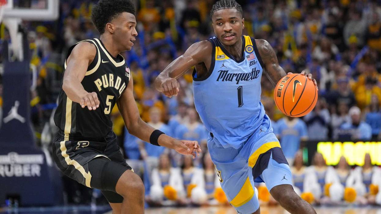 Nov 19, 2024; Milwaukee, Wisconsin, USA; Marquette Golden Eagles head coach Shaka Smart talks with guard Kam Jones (1) during the second half against the Purdue Boilermakers at Fiserv Forum. Mandatory Credit: Jeff Hanisch-Imagn Images