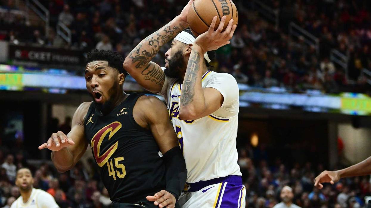 Nov 25, 2023; Cleveland, Ohio, USA; Los Angeles Lakers forward Anthony Davis (3) drives to the basket against Cleveland Cavaliers guard Donovan Mitchell (45) during the second half at Rocket Mortgage FieldHouse.