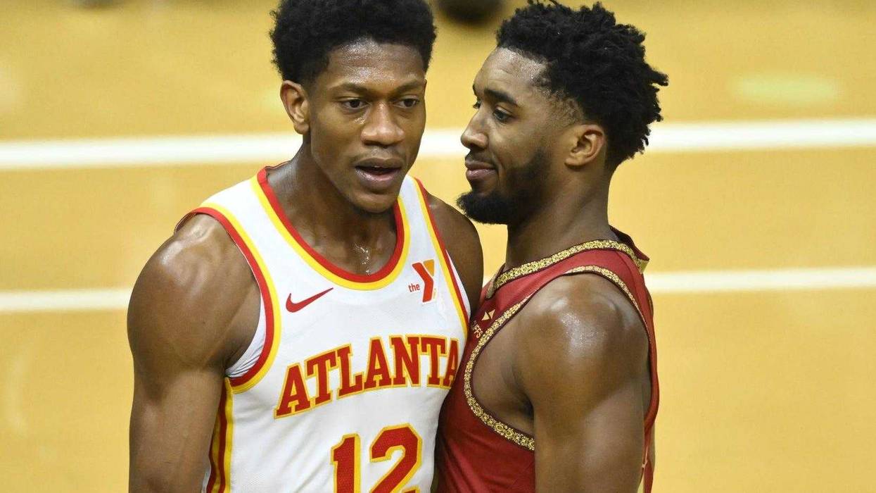 Nov 28, 2023; Cleveland, Ohio, USA; Cleveland Cavaliers guard Donovan Mitchell (45) reacts beside Atlanta Hawks forward De'Andre Hunter (12) in the fourth quarter at Rocket Mortgage FieldHouse.