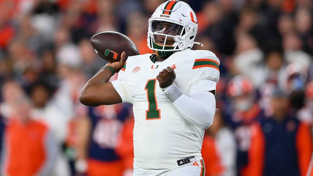 Nov 30, 2024; Syracuse, New York, USA; Miami Hurricanes quarterback Cam Ward (1) passes the ball against the Syracuse Orange during the first half at the JMA Wireless Dome.