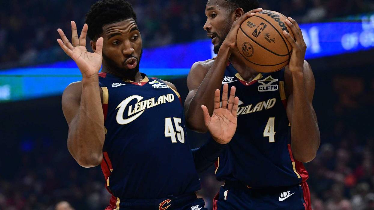 Nov 30, 2025; Cleveland, Ohio, USA; Cleveland Cavaliers guard Donovan Mitchell (45) gets out of the way as center Evan Mobley (4) grabs a rebound during the first half at Rocket Arena.