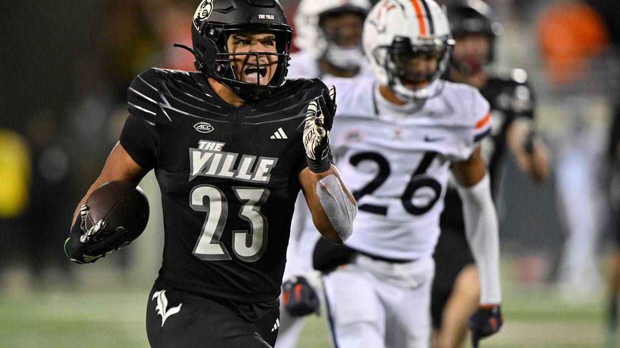 Nov 9, 2023; Louisville, Kentucky, USA; Louisville Cardinals running back Isaac Guerendo (23) runs the ball against the Virginia Cavaliers to score a touchdown during the second half at L&N Federal Credit Union Stadium. Louisville defeated Virginia 31-24.