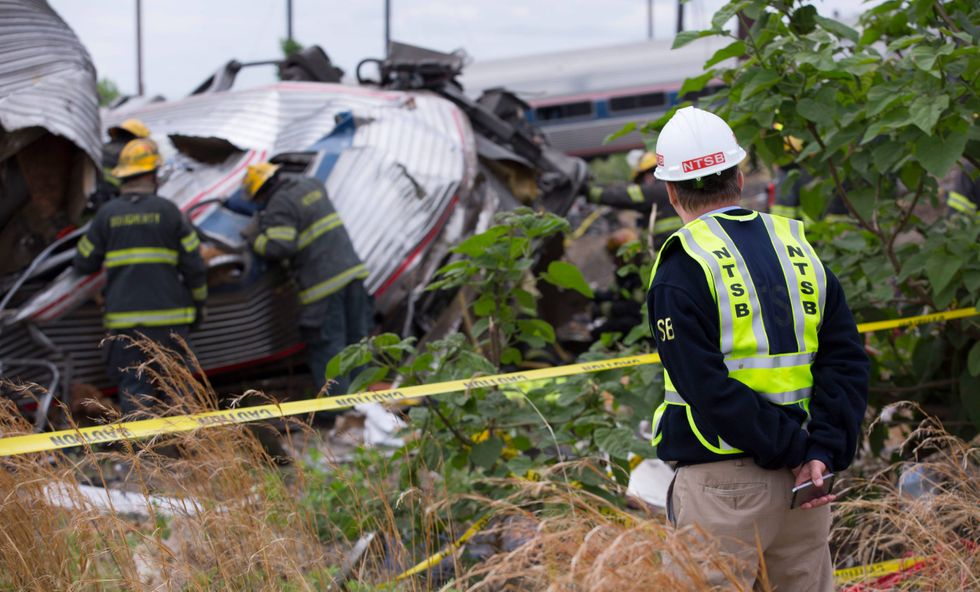 NTSB member Robert Sumwalt works on the scene of the Amtrak train derailment on May 13, 2015 in Philadelphia, Pennsylvania.
